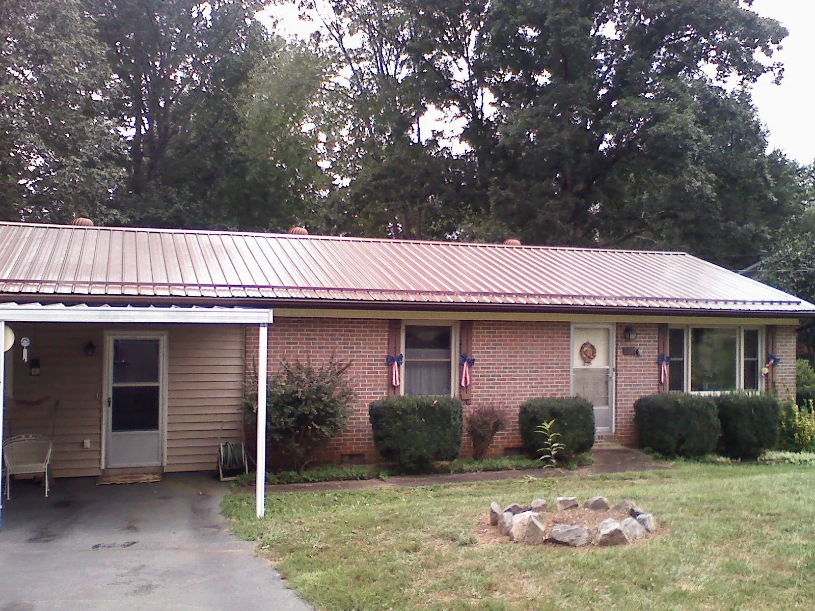 Bronze metal roof and carport on a brick ranch home — Roof Repair work by our crew in Nahant